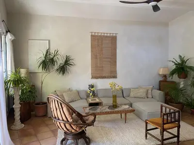 a living room with a couch and a table at Maison Loucacia in Mormoiron