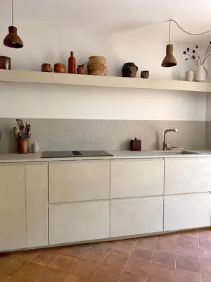 a kitchen with white cabinets and a sink at Maison Loucacia in Mormoiron
