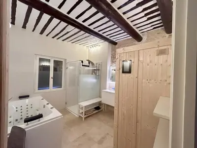 a bathroom with a tub and a shower and a sink at Magnifique Mas provencal au coeur des vignes in Mazan