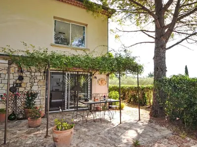 a patio with a table and chairs in front of a house at Apartment Les Santons by Interhome in Peypin-dʼAigues