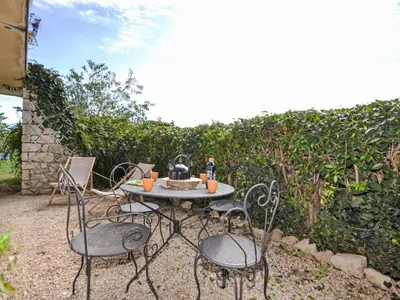 a table with two chairs and a tea kettle on it at Apartment Les Santons by Interhome in Peypin-dʼAigues