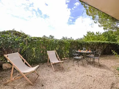 two chairs and a table in a yard at Apartment Les Santons by Interhome in Peypin-dʼAigues