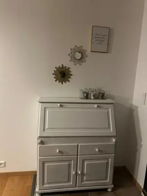 a white dresser in a room with a mirror at Le laurier, confort et calme en Provence in Noves