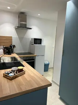 a kitchen with a wooden counter top with a counter top at Le laurier, confort et calme en Provence in Noves