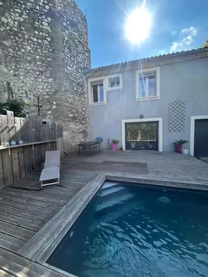 a house with a swimming pool in front of a house at Le laurier, confort et calme en Provence in Noves