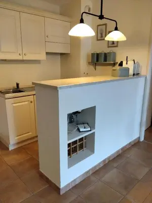 a kitchen with a fireplace in the middle of it at Golf de saumane in Saumane-de-Vaucluse
