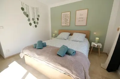 a bedroom with a bed with two blue pillows on it at Villa with heated pool and Ventoux View in Pernes in Pernes-les-Fontaines