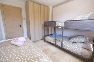 a bedroom with two bunk beds and a door at Villa with heated pool and Ventoux View in Pernes in Pernes-les-Fontaines