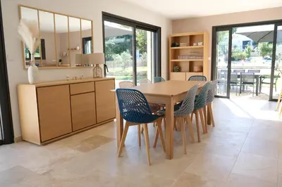 a dining room with a wooden table and chairs at Villa with heated pool and Ventoux View in Pernes in Pernes-les-Fontaines