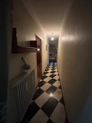 a hallway with a black and white checkered floor at Maison Provençale au centre du village in Mollégès