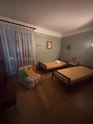 a room with two beds and a couch and a chair at Maison Provençale au centre du village in Mollégès