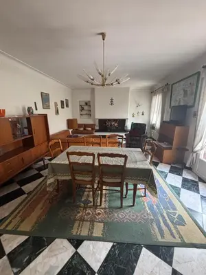 a living room with a dining table and chairs at Maison Provençale au centre du village in Mollégès