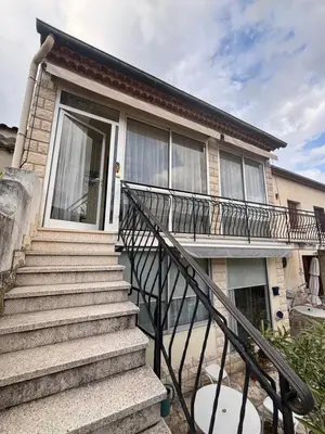 a house with a staircase in front of it at Maison Provençale au centre du village in Mollégès
