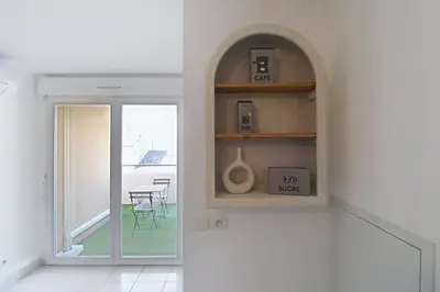 a kitchen with a window and a room with a table at Le Nid du Pradon in Cavaillon