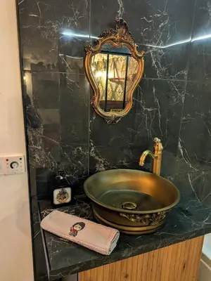 a bathroom with a sink and a mirror on a counter at Le Repaire du Sorcier in Caumont-sur-Durance