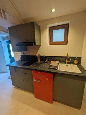 a kitchen with a sink and a counter top at Le Repaire du Sorcier in Caumont-sur-Durance