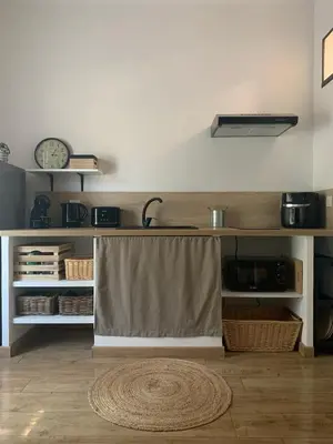 a kitchen with a sink and a counter top at Studio cosy à la campagne in Montjustin