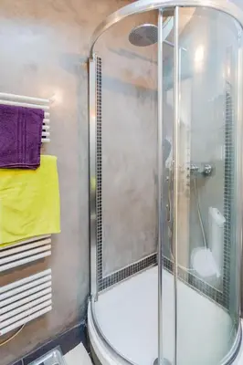 a shower with a glass door in a bathroom at Urban loft with terrace downtown in Aix-en-Provence