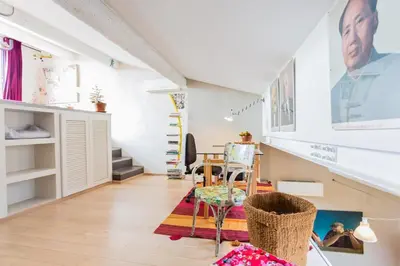 a living room with a table and a dining room at Urban loft with terrace downtown in Aix-en-Provence