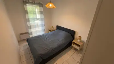a small bedroom with a bed and a window at Magnifique T2 Aix-en-Provence in Aix-en-Provence