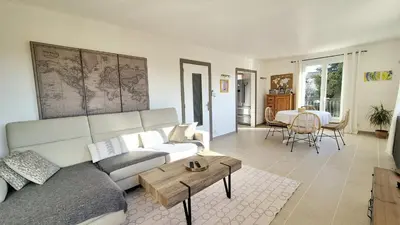 a living room with a couch and a table at La casemate in LʼIsle-sur-la-Sorgue