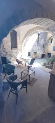 a kitchen with a refrigerator and a table in a room at Magnifique demeure de caractère au cœur de Lacoste in Lacoste