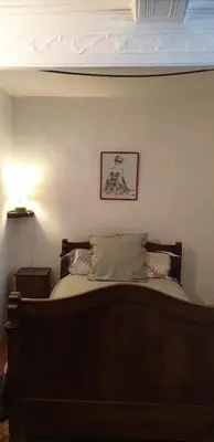 a room with a wooden door and pictures on the wall at Magnifique demeure de caractère au cœur de Lacoste in Lacoste