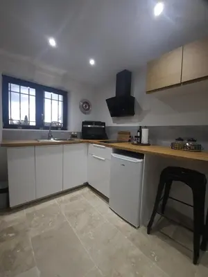a kitchen with white cabinets and a counter top at Duplex Design - Clim - Parking privé - Wifi - by CommeChezSoi in Vedène