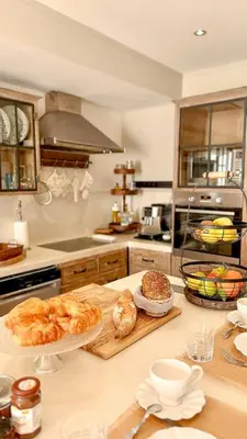 a kitchen with croissants and bread on a counter at Modern Villa With Views Of Gordes in Gordes