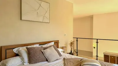 a bedroom with a bed with a picture on the wall at Modern Villa With Views Of Gordes in Gordes