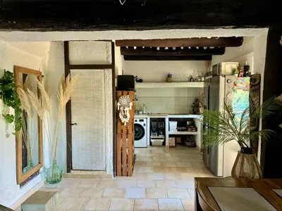 a kitchen with a white refrigerator and a stove at Charmant mas perché en Provence in Saumane-de-Vaucluse