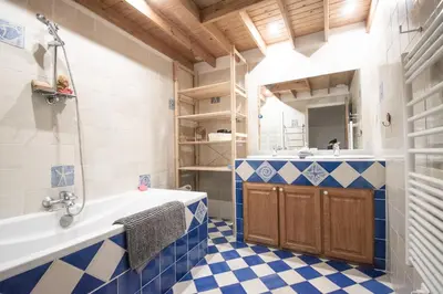 a kitchen with a table and a hallway in the background at La maison du Roy in Aix-en-Provence