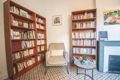 a hallway with a room with a bed and a book shelf at La maison du Roy in Aix-en-Provence