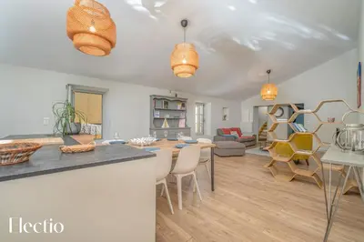 a kitchen and living room with a table and chairs at Château Constantin in Cadenet