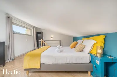 a bedroom with a large bed with yellow and blue at Château Constantin in Cadenet
