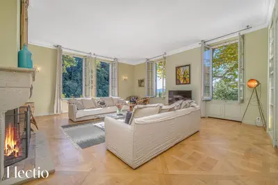 a living room with a couch and a fireplace at Château Constantin in Cadenet