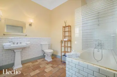 a bathroom with a sink and a tub and a toilet at Château Constantin in Cadenet