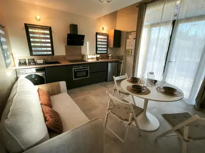 a living room with a couch and a table at Le Mazet de Christol in Eygalières
