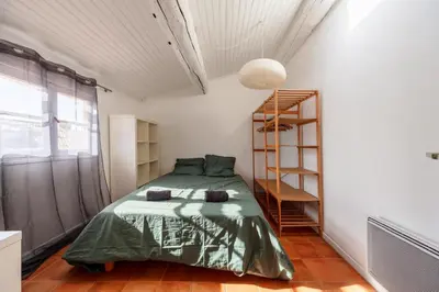 a bedroom with a green bed and a ladder at Les Toits d'Aix - Hyper center - Cours Mirabeau - Lumineux in Aix-en-Provence
