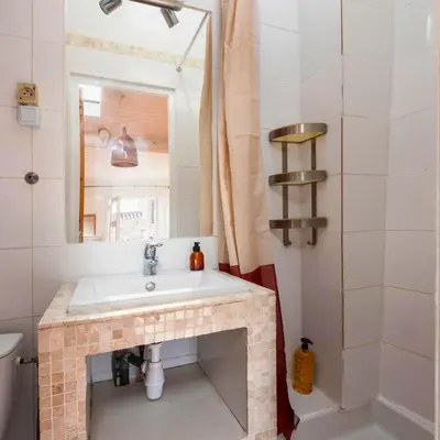 a bathroom with a sink and a mirror at Les Toits d'Aix - Hyper center - Cours Mirabeau - Lumineux in Aix-en-Provence