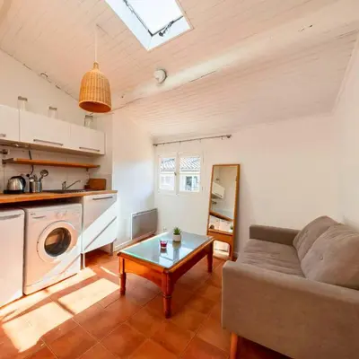 a living room with a couch and a table at Les Toits d'Aix - Hyper center - Cours Mirabeau - Lumineux in Aix-en-Provence