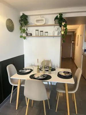 a dining room with a white table and chairs at L'Odelisle Appartement plein centre avec terrasse in LʼIsle-sur-la-Sorgue