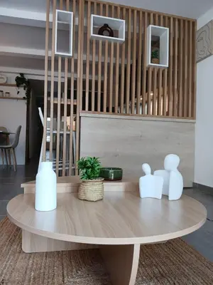 a table with three white vases on top of it at L'Odelisle Appartement plein centre avec terrasse in LʼIsle-sur-la-Sorgue
