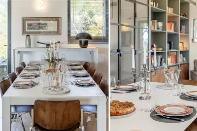 a long white table with chairs and plates on it at Madame Luberon in Roussillon
