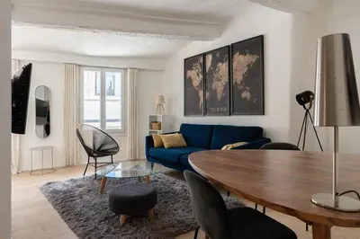 a living room with a blue couch and a table at Sweet Home in Aix-en-Provence