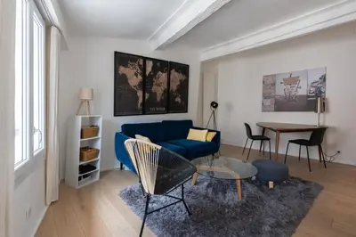 a living room with a blue couch and a table at Sweet Home in Aix-en-Provence