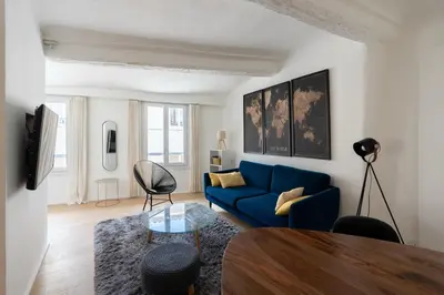 a living room with a blue couch and a table at Sweet Home in Aix-en-Provence