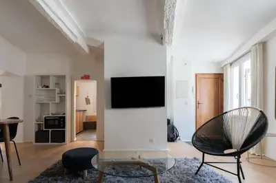 a living room with a tv on a white wall at Sweet Home in Aix-en-Provence
