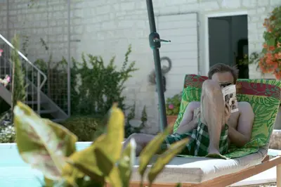 a man laying in a chair reading a book at Maison Pertuis Provence in Pertuis