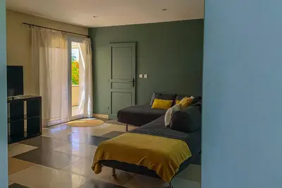 a living room with a bed and a couch at Maison Pertuis Provence in Pertuis